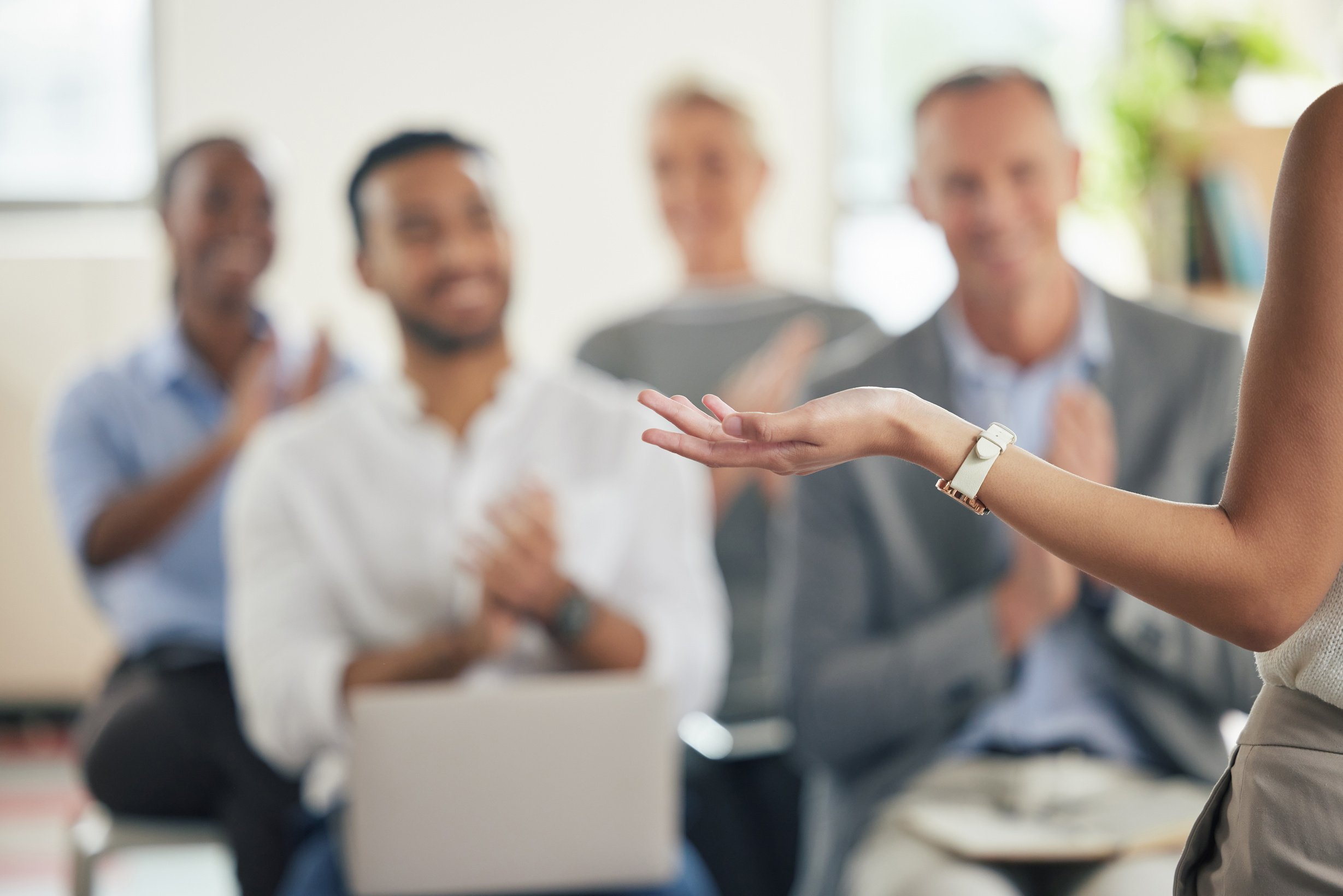 Shot of a group of business people applauding during a presentation